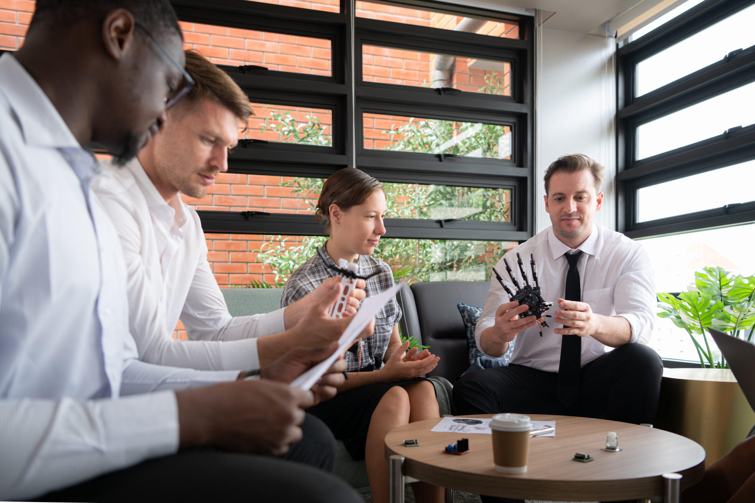 Group of diverse business people working together in the office, Brainstorming about the hand robot model to be used for production work
